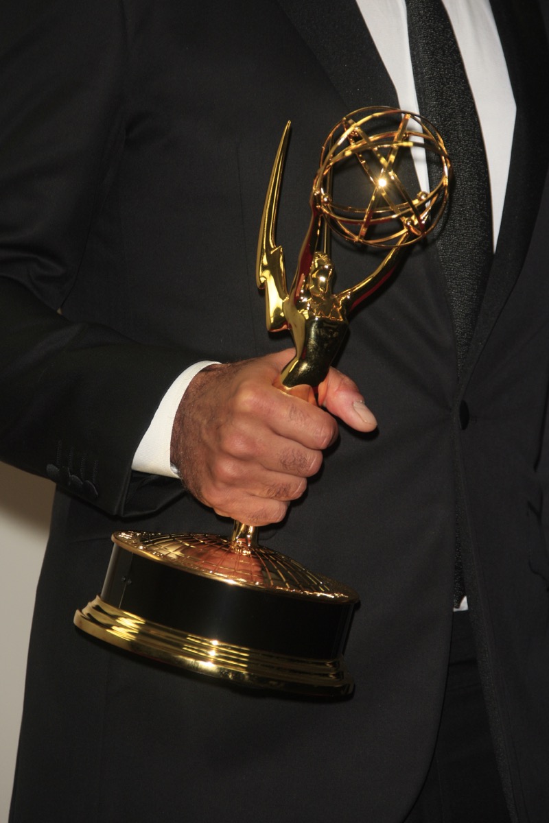 Black hand holding Emmy statue