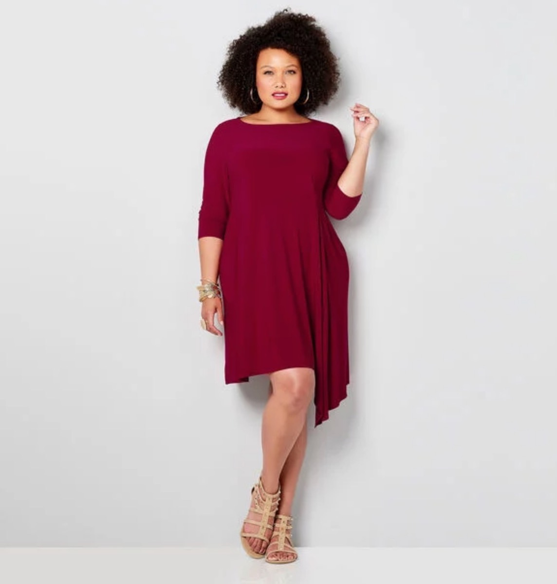 woman wearing knee length burgundy dress against gray background, fall dresses