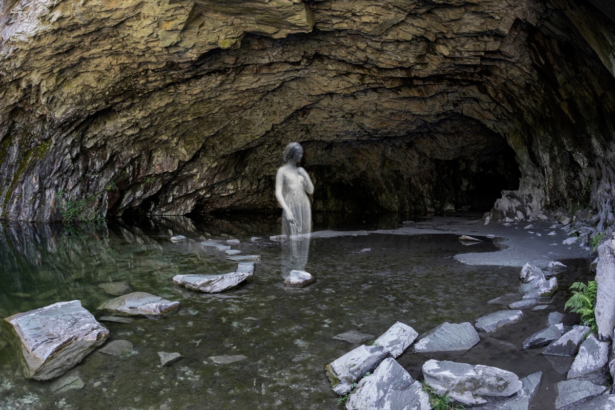 ghost of woman in front of cave