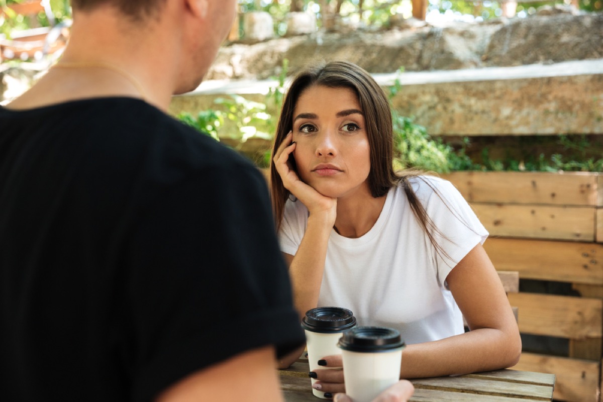 woman having coffee and looking bored on outdoor date, worst things about the suburbs