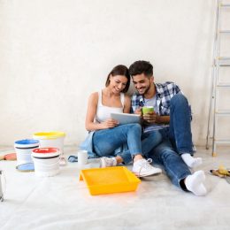 a couple paints a room