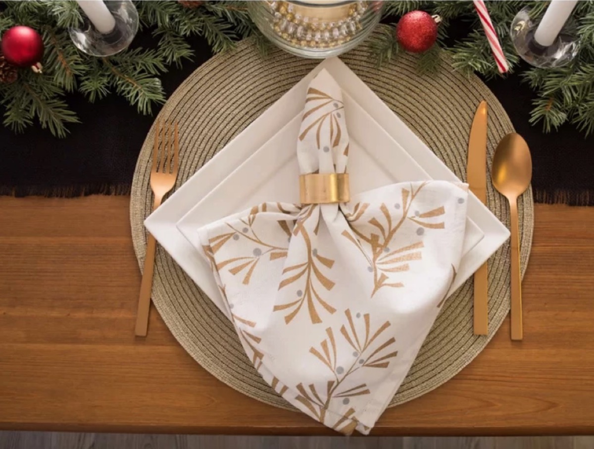 square white plates, gold-toned silverware, and white napkin with gold leaves, fall decorating tips