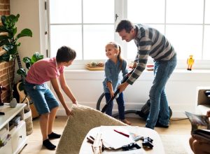 man and two children cleaning living room, earth friendly cleaning products