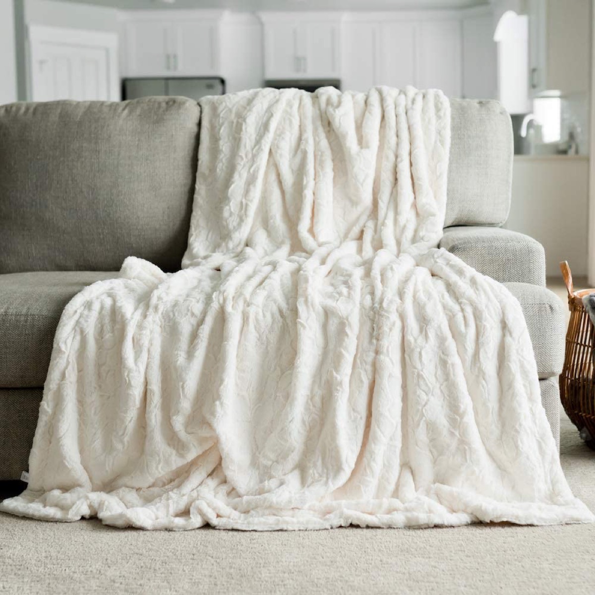 white faux fur throw draped over couch