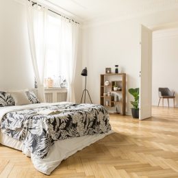 herringbone floor in airy sunny bedroom