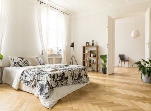 herringbone floor in airy sunny bedroom