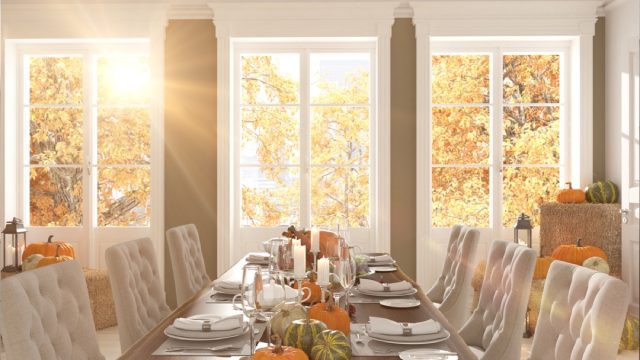 dining room table with pumpkins and leaves on it, dollar store fall decor