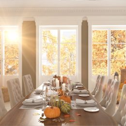 dining room table with pumpkins and leaves on it, dollar store fall decor