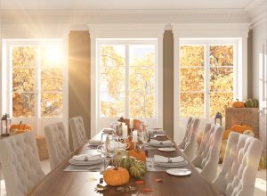 dining room table with pumpkins and leaves on it, dollar store fall decor