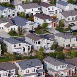 a view of a traditional cookie cutter american suburb from like helicopter height
