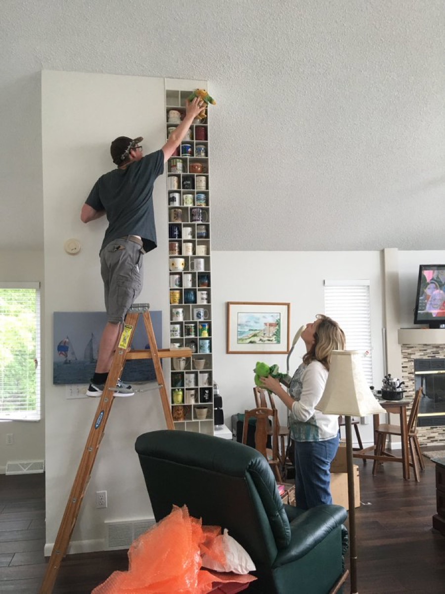 a man building a rack for his girlfriend's mugs, heartwarming photos