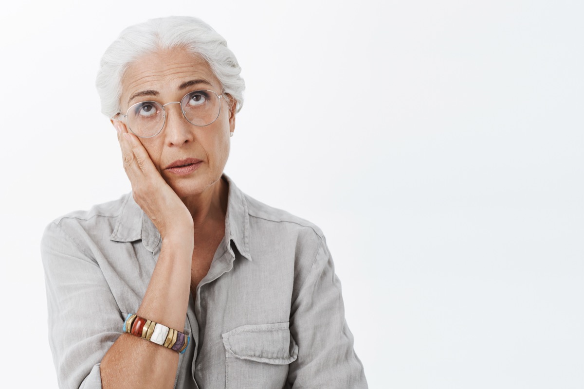 older woman sighing, stress signs