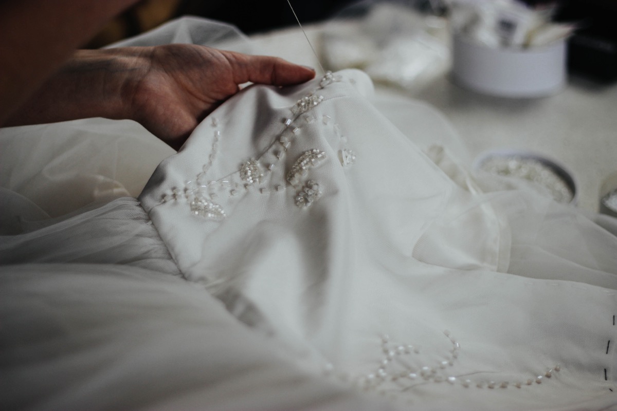Designer sewing a wedding dress
