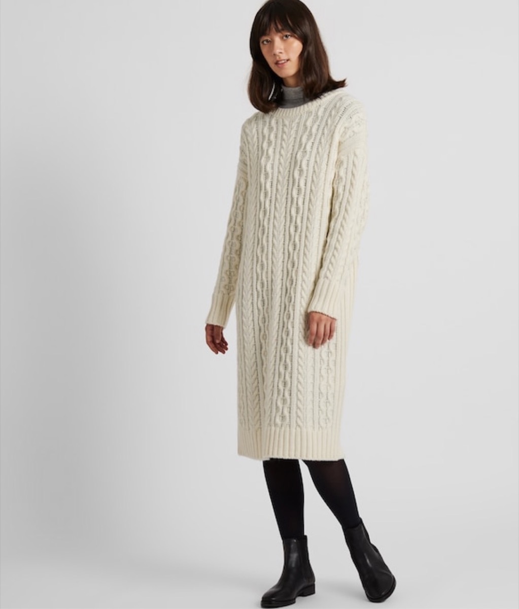 woman wearing cream colored sweater dress and black tights, fall dresses