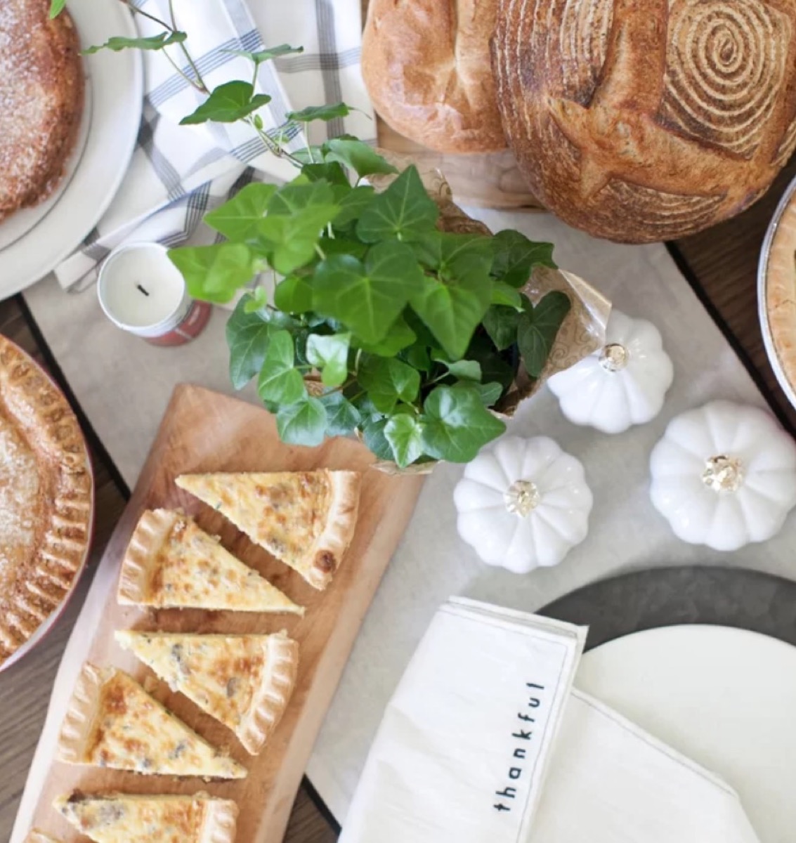white pumpkins on table with quiche and bread, fall decorating tips