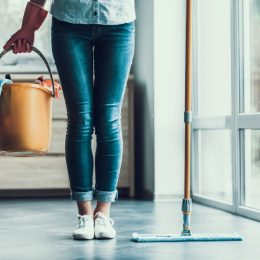 woman holding cleaning bucket, essential home supplies