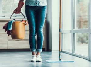 woman holding cleaning bucket, essential home supplies