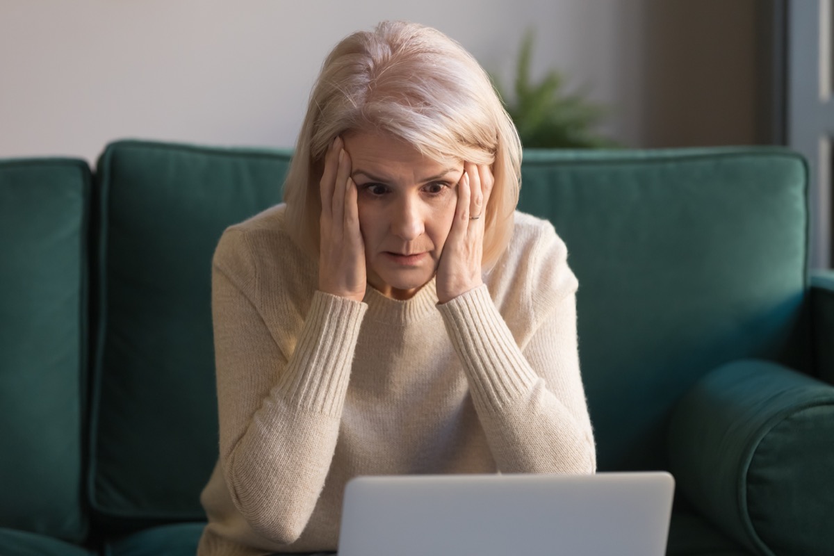 older woman angry in front of laptop