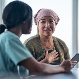 an older woman talking to her doctor while in the office