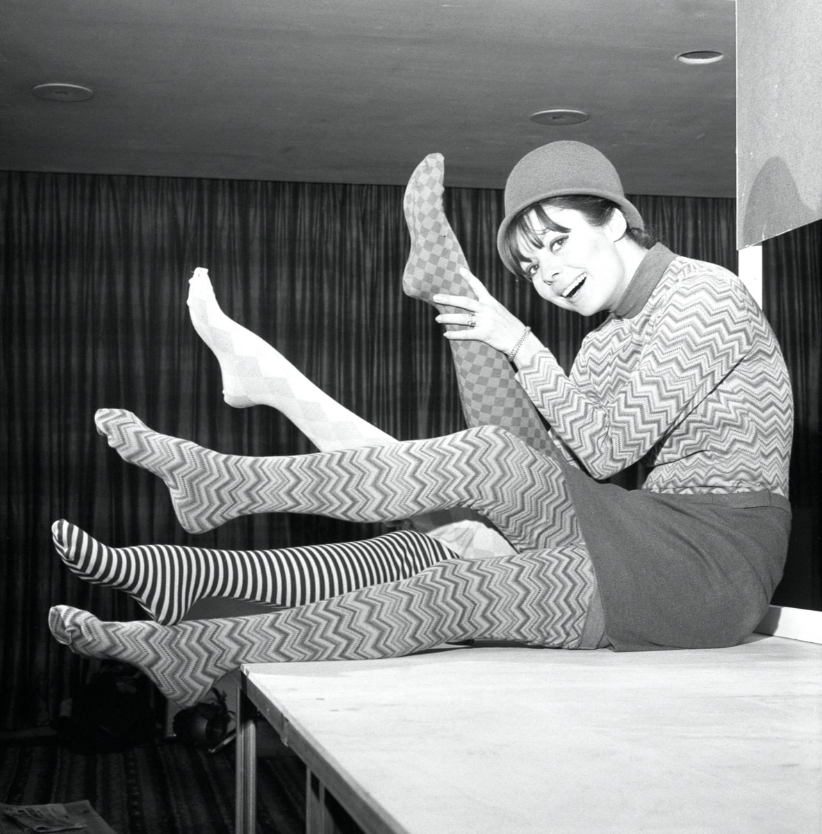 black and white photo of woman in 1960s wearing patterned tights