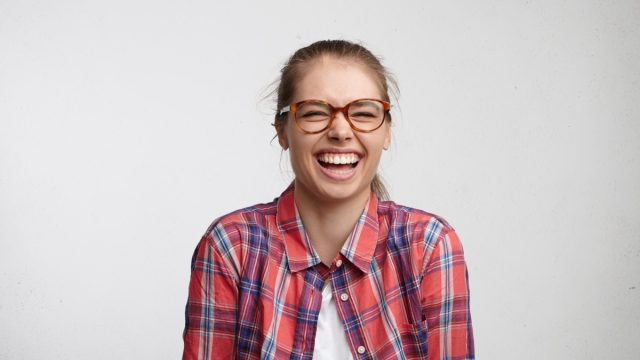 Woman in glasses laughing