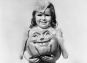 vintage halloween photo of a girl and her pumpkin