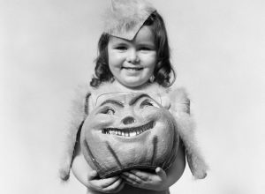 vintage halloween photo of a girl and her pumpkin