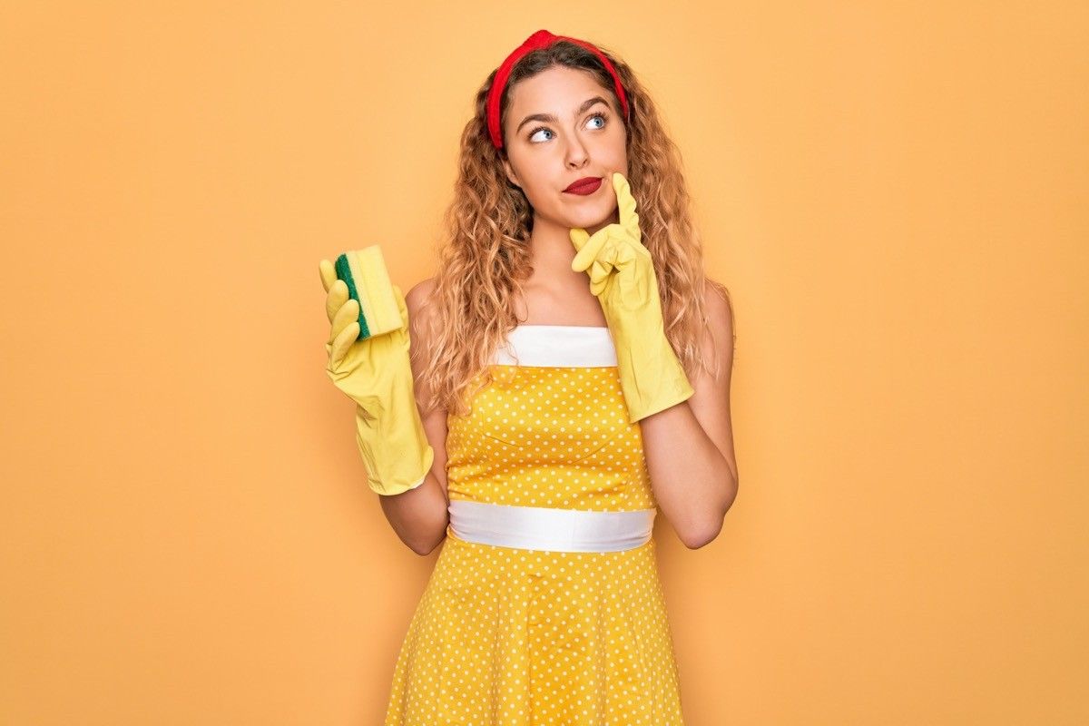 https://bestlifeonline.com/wp-content/uploads/sites/3/2019/10/Woman-in-yellow-dress-and-cleaning-gloves.jpg?quality=82&strip=all