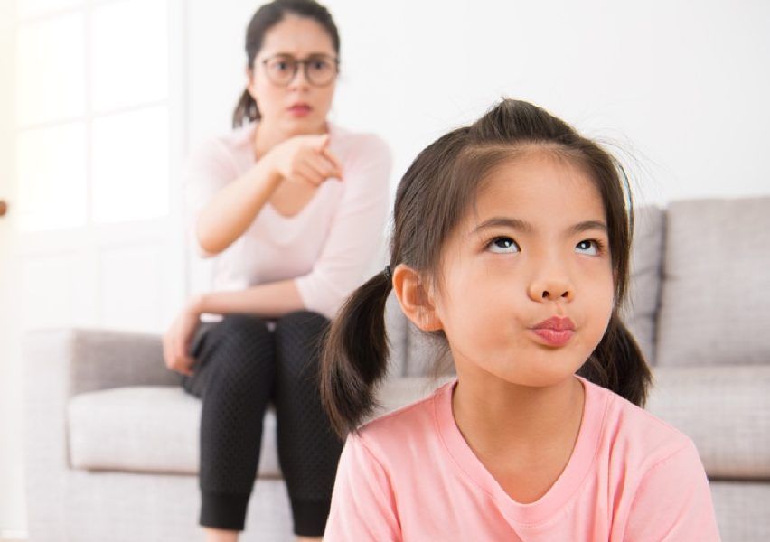 asian girl annoyed at scolding mom