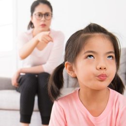 asian girl annoyed at scolding mom