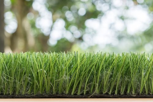 a close-up photo of artificial turf outside someone's yard