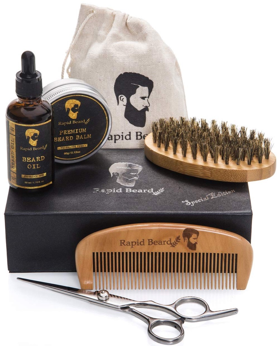 beard oil, comb, brush, scissors, and pomade on black box