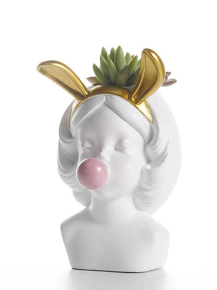 white ceramic vase with girl in gold bunny ears blowing bubble gum