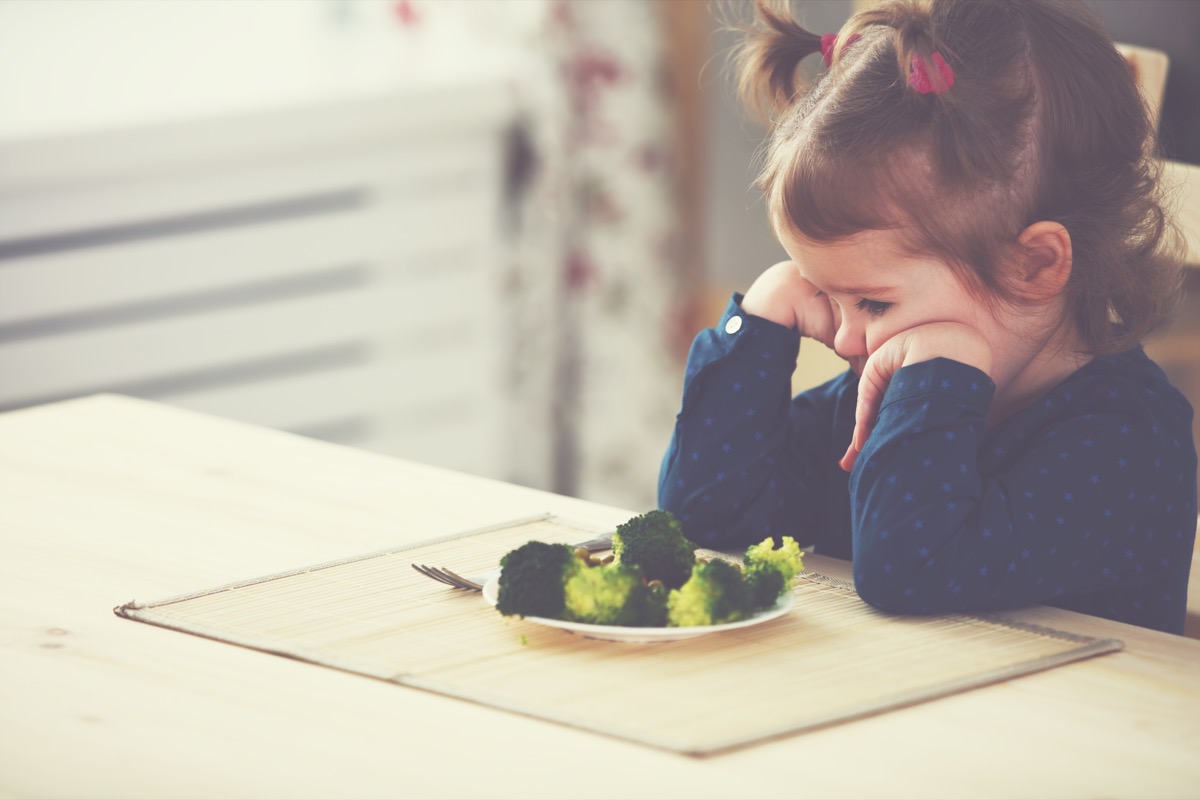 child eating broccoli