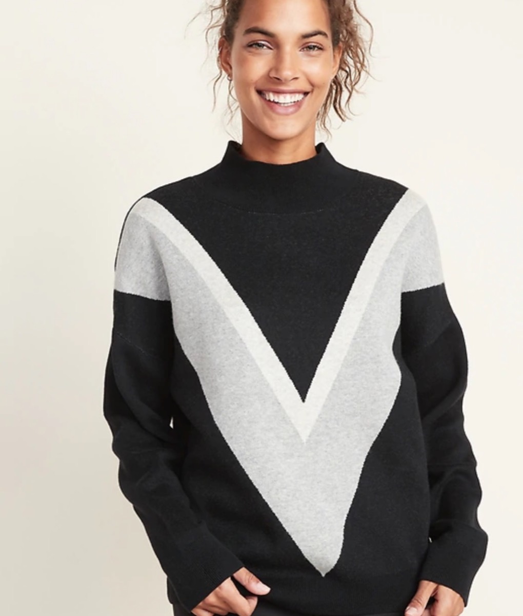 woman in colorblocked black mock v-neck sweater