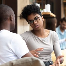 black man and woman talking outdoors