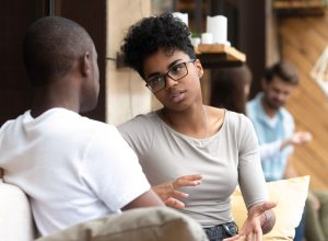 black man and woman talking outdoors