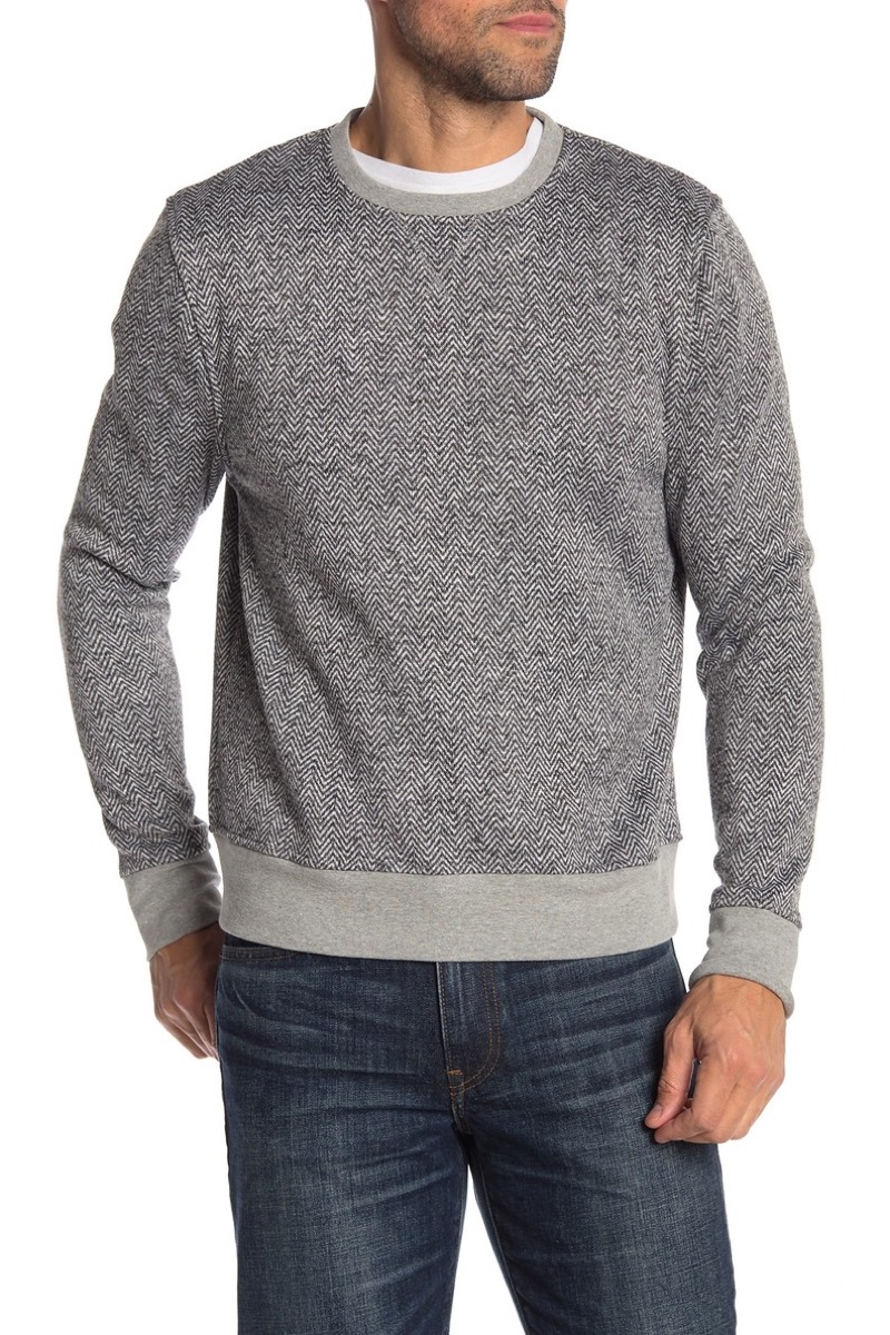man wearing gray sweatshirt and jeans