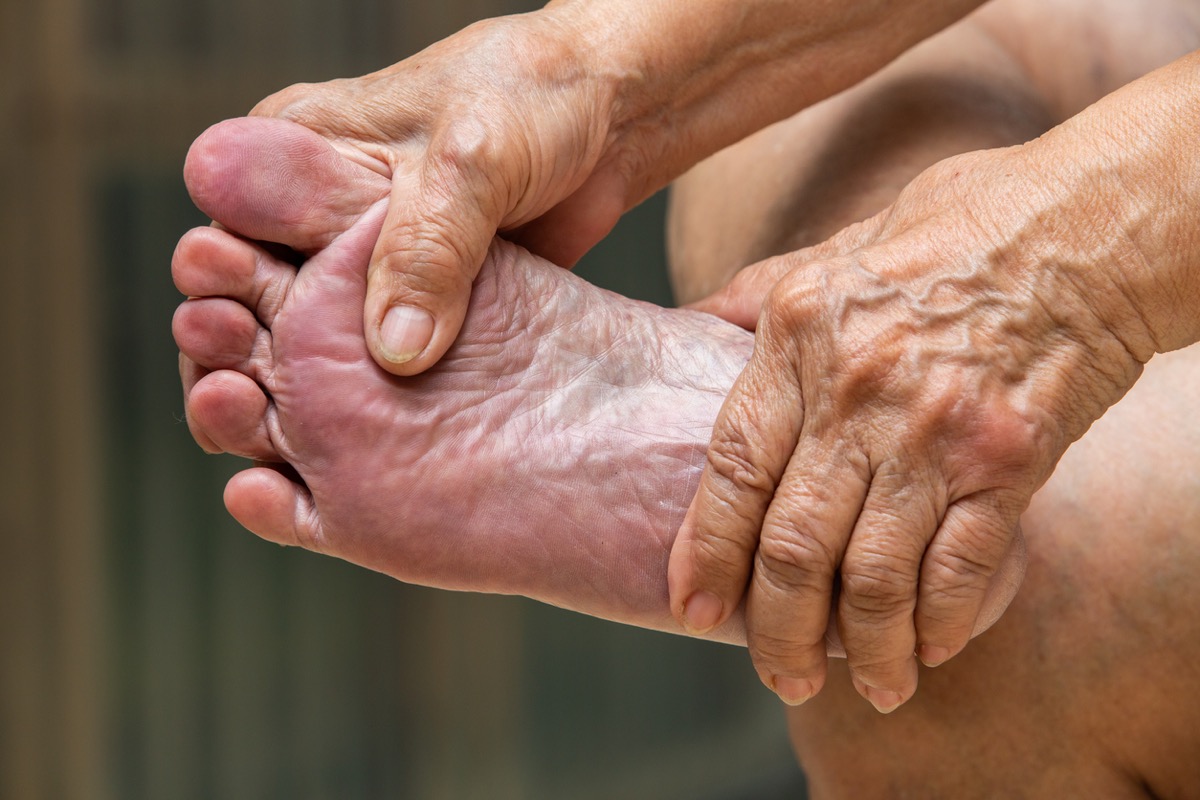 Senior woman's hands massaging her foot