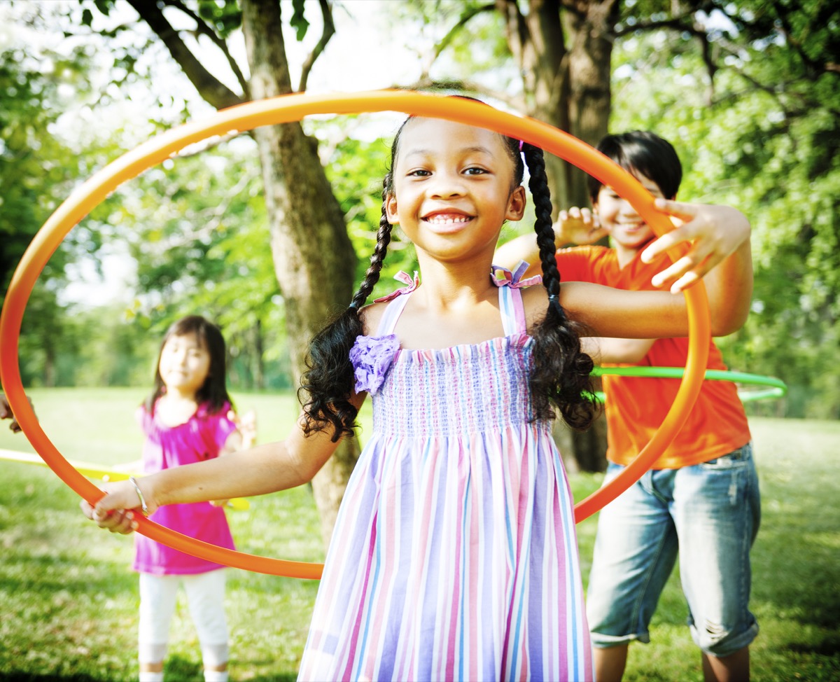 kids hula hooping at a park