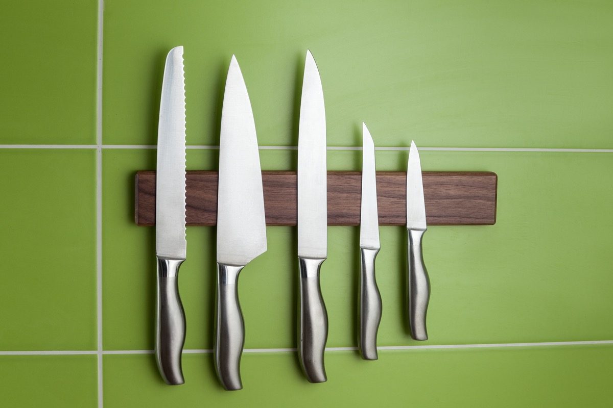 magnetic knife rack on green wall