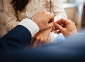 man clasping bracelet on woman's wrist, etsy jewelry