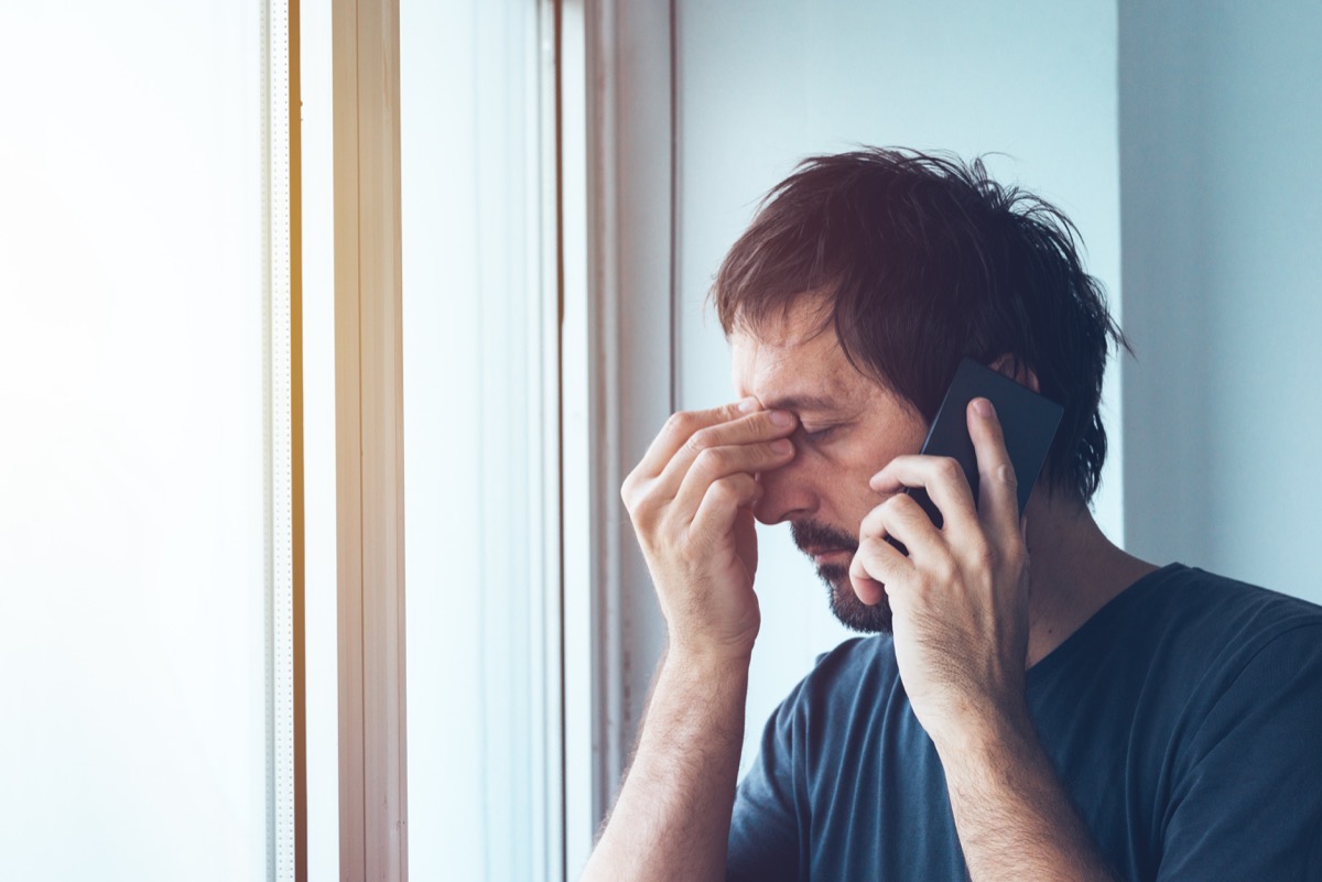 man upset with telemarketing robocalls while talking to a telemarketer on a cell phone