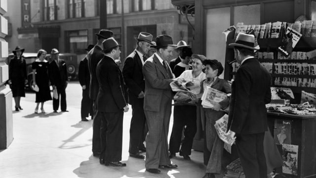 men buying newspapers from newsboys shouting extra extra in the middle of the 20th century