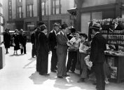 men buying newspapers from newsboys shouting extra extra in the middle of the 20th century
