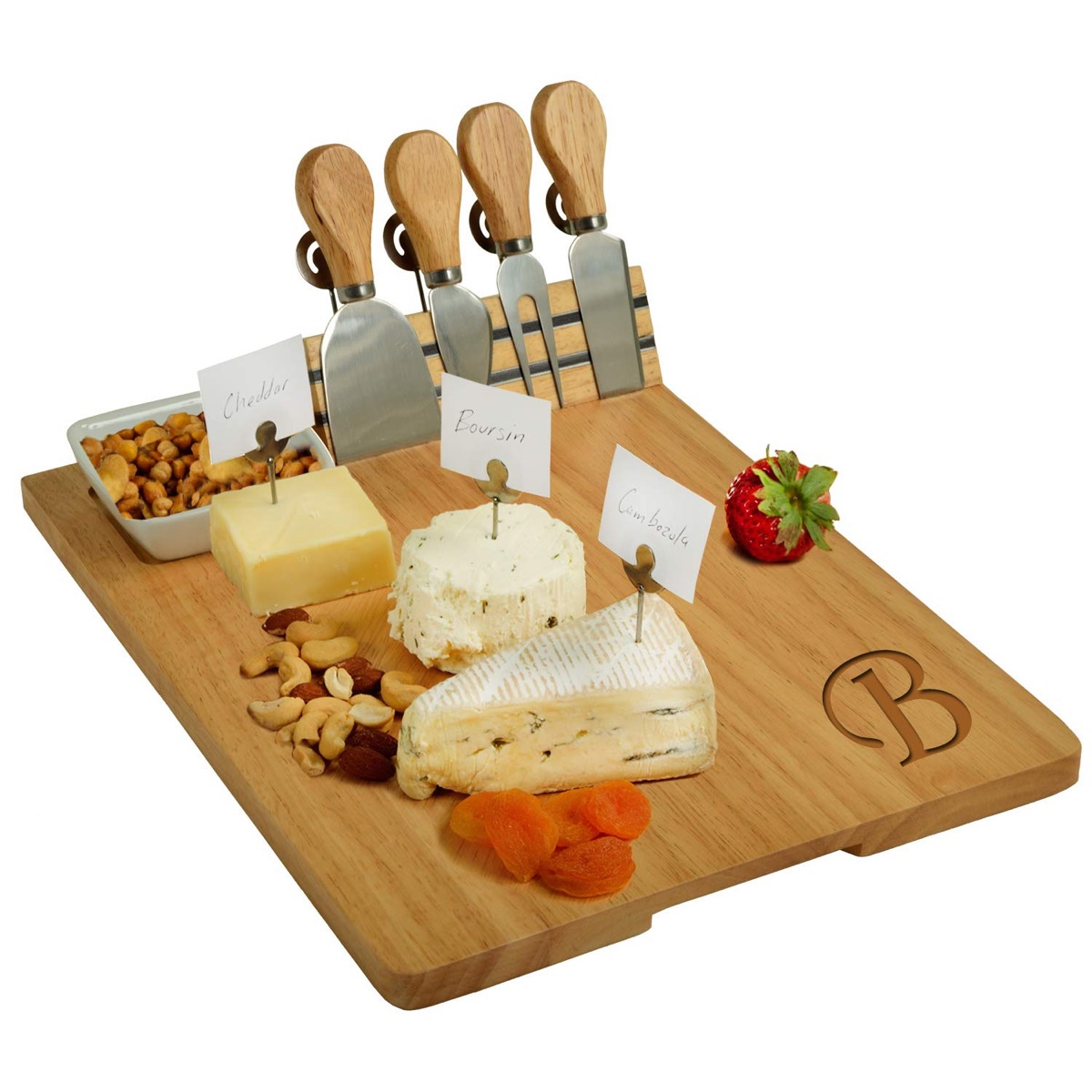 wooden cheese board with letter on it and wedges of cheese and a dish of nuts