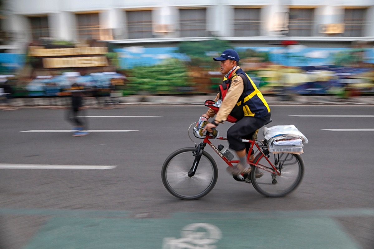 newspaper delivery man on bike