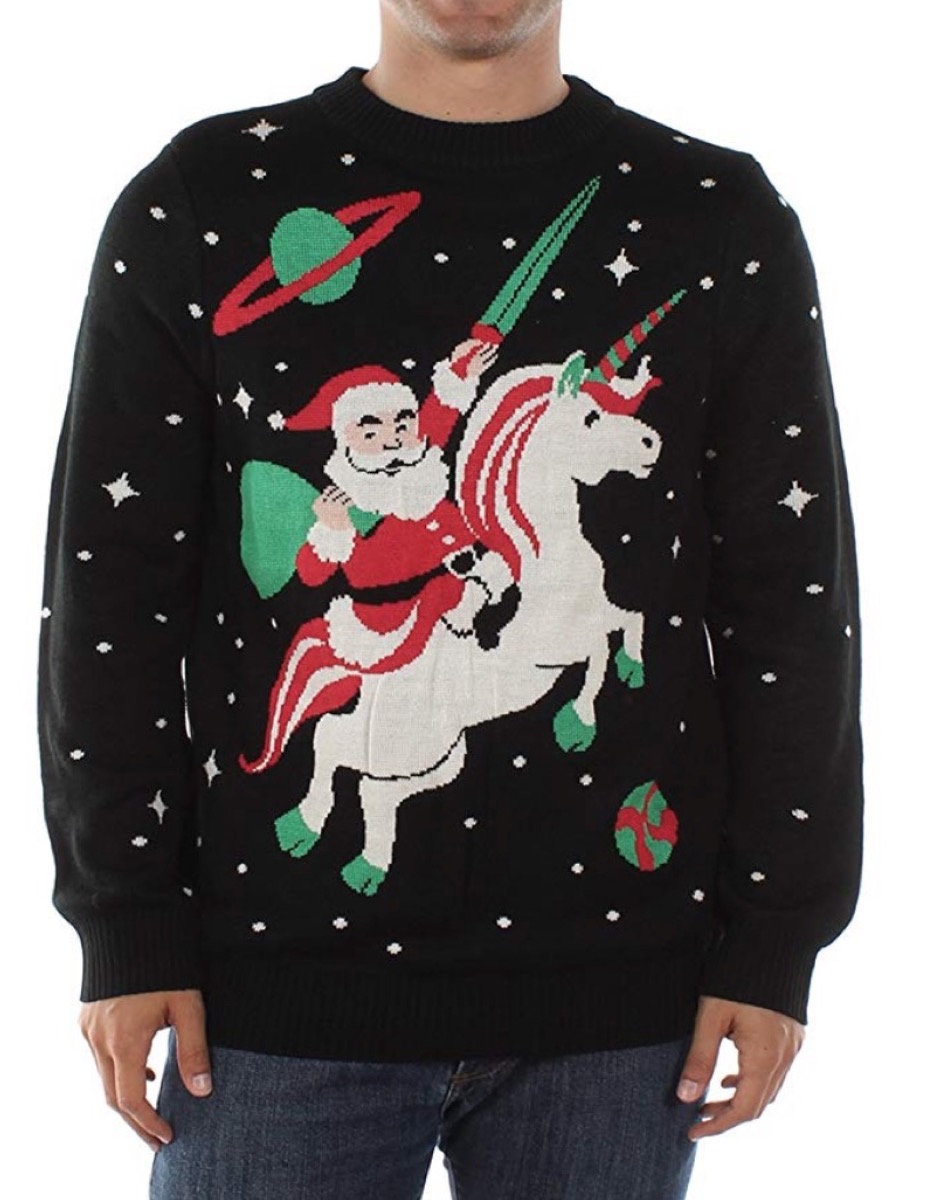 black sweater with santa riding a unicorn on it