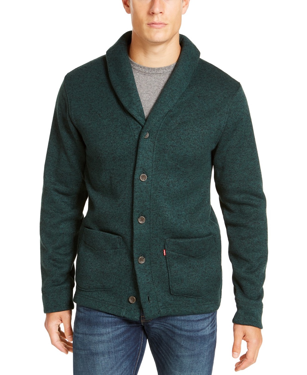 man wearing green cardigan and jeans