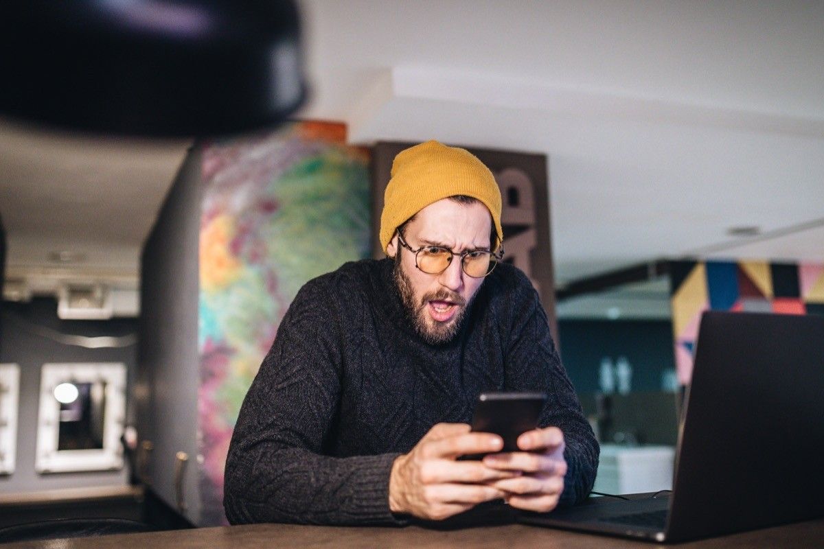 Handsome and fashionable bearded hipster influencer, with mouth open from the shocking news.